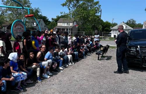  students sitting on playground